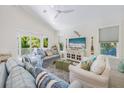 Comfortable living room featuring stylish furniture, sliding glass doors to the patio, and coastal-themed decor at 418 Magnolia Ave, Anna Maria, FL 34216