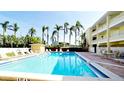 Outdoor pool showcasing the clear blue water and surrounding lounge area for relaxation at 4200 Gulf Dr # 101, Holmes Beach, FL 34217