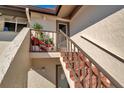 Exterior staircase showcasing brick steps, neutral stucco walls, and a cozy potted plant display at 4234 Gulf Of Mexico Dr # H2, Longboat Key, FL 34228