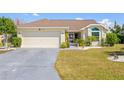 Charming single Gathering home featuring a two-car garage, well-manicured lawn and lovely landscaping at 4809 11Th Avenue E Cir, Bradenton, FL 34208