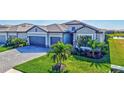 Attractive home exterior showcasing lush landscaping, paver driveway, and a three-car garage at 4968 Seafoam Trl, Bradenton, FL 34211