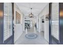 Inviting foyer with tile flooring, elegant lighting, and an open view into the living spaces at 4968 Seafoam Trl, Bradenton, FL 34211