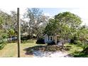 Inviting single-story home with a well-maintained lawn, mature trees, and classic architectural charm at 617 35Th W St, Bradenton, FL 34205