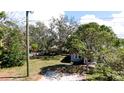 Inviting single-story home with a well-maintained lawn, mature trees, and classic architectural charm at 617 35Th W St, Bradenton, FL 34205