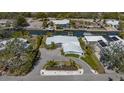 Waterfront home featuring a boat dock, canal access, and stylish landscaping at 619 Buttonwood Dr, Longboat Key, FL 34228