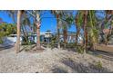 Charming single-Gathering home featuring mature landscaping, a large garage, and blue shutters at 710 Birdsong Ln, Sarasota, FL 34242