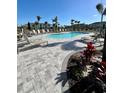 Resort-style pool with lounge chairs and lush tropical landscaping, perfect for relaxation at 8949 Daybreak St, Sarasota, FL 34241
