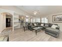 Inviting living room with vaulted ceiling provides seamless flow to kitchen, dining, and staircase at 11744 Shirburn Cir, Parrish, FL 34219