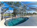 Beautiful screened-in pool area with a clear blue pool and serene water view at 11744 Shirburn Cir, Parrish, FL 34219