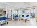 Inviting living room with ocean view balcony access, comfortable seating, and glimpses into the Primary bedroom at 1255 Tarpon Center Dr # 315, Venice, FL 34285