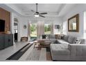 Bright living room featuring tile floors, a large sectional sofa, and access to the backyard at 13540 Old Creek Ct, Parrish, FL 34219