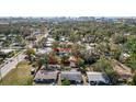 Aerial view of a single-Gathering home, outlined in red, nestled among lush greenery and neighboring houses at 1367 21St St, Sarasota, FL 34234