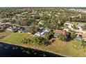 Aerial view of a home with screened-in porch overlooking a pond in a treed neighborhood at 14730 1St E Ave, Bradenton, FL 34212