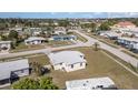Overhead view of a charming single-Gathering home situated in a tranquil residential area with verdant surroundings at 211 Dalton Blvd, Port Charlotte, FL 33952
