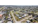 Neighborhood aerial showcases cozy homes, lush greenery, and convenient access to local amenities at 211 Dalton Blvd, Port Charlotte, FL 33952