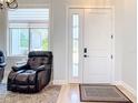 Welcoming entryway with stylish door and window, adjacent to a cozy living space at 2186 Yalta Ter, North Port, FL 34286