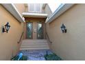 Inviting front entrance with double doors, stone walkway, sconces, and manicured landscaping at 322 Winding Brook Ln # 103, Bradenton, FL 34212