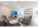 Spacious living room featuring a large flat screen tv and comfortable seating arrangements at 3802 Savanna Palms Ct, Bradenton, FL 34211