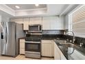 Modern kitchen with stainless steel appliances, granite countertops, and light wood cabinets at 4608 Park Acres Dr, Bradenton, FL 34207