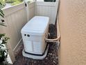 Generac home generator installed in the backyard near the wall and fence at 5020 Savona Run, Bradenton, FL 34211