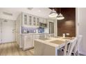 Stylish kitchen features white cabinetry, stainless appliances, and pendant lighting at 250 Sands Point Rd # 5101, Longboat Key, FL 34228