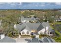 Spacious property featuring a well-maintained lawn, mature trees, and a large driveway at 4563 Whirlaway Dr # C, Sarasota, FL 34233