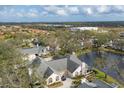 Aerial view of a home with a pond, lush greenery, and neighboring properties at 4563 Whirlaway Dr # C, Sarasota, FL 34233