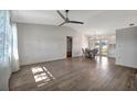Bright and airy living room with modern flooring, a ceiling fan, and a view into the dining area at 5115 Island Date Way, Sarasota, FL 34232
