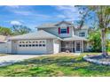 Charming two-story home with a well-manicured lawn, garage, and screened-in porch at 6145 Bonaventure Ct, Sarasota, FL 34243