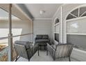 Cozy screened-in porch with comfortable seating, perfect for relaxing outdoors at 6145 Bonaventure Ct, Sarasota, FL 34243