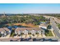 Aerial view of a residential community with a pool, pond, playground, and surrounding green spaces at 6634 Calypso Coral Ln, Sarasota, FL 34240