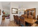 Elegant dining room featuring a wooden table, upholstered chairs, and a decorative chandelier at 2630 Moss Oak Dr # 50, Sarasota, FL 34231