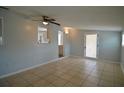 Bright living room featuring tile flooring, a ceiling fan, and glass panel back door at 321 40Th Street Nw Ct, Bradenton, FL 34209