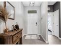 Inviting foyer featuring tile flooring and a stylish entryway table at 4034 Mossy Limb Ct, Palmetto, FL 34221