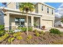 Charming two-story home featuring a well-landscaped front yard with a young palm tree at 5117 Sultana Cv, Bradenton, FL 34211