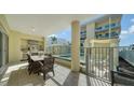 Inviting patio area with outdoor kitchen, dining space, and pool view at 6512 Midnight Pass Rd # 206, Sarasota, FL 34242