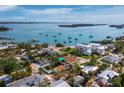 Aerial view of a waterfront community with sailboats and a private beach at 691 Linley St, Longboat Key, FL 34228