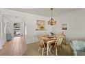 Cozy dining room with an adjacent pass-through to the kitchen and view of the front door at 7860 Palm Aire Ln # 104, Sarasota, FL 34243