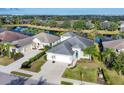 Aerial view of a well maintained home with a pool and lake in a beautiful neighborhood at 12046 Forest Park Cir, Bradenton, FL 34211