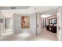 Bright, open foyer featuring tile floors, recessed lighting, modern artwork, and an elegant console table at 1241 Gulf Of Mexico Dr # 1005, Longboat Key, FL 34228