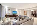 Spacious living room with modern sofas, contemporary art, recessed lights, and access to the foyer at 1241 Gulf Of Mexico Dr # 1005, Longboat Key, FL 34228