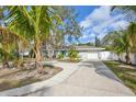 Attractive home featuring mature palm trees and a large, curved driveway at 1409 2Nd E Ave, Bradenton, FL 34208