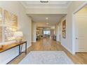 Elegant entryway with wood-look tile floors, neutral walls, and decor that enhances a welcoming ambiance at 16218 Umbria Pl, Bradenton, FL 34211