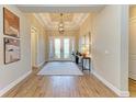 Elegant entryway with wood-look tile floors, neutral walls, and decor that enhances a welcoming ambiance at 16218 Umbria Pl, Bradenton, FL 34211