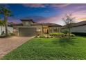 Charming single-story home with a well-manicured lawn, beautiful landscaping, and a tile roof at 16218 Umbria Pl, Bradenton, FL 34211