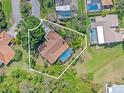 Aerial view of the property showcasing its private pool, mature trees, and well-defined property lines at 3970 Country View Dr, Sarasota, FL 34233