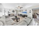 Open living area with neutral decor, a large TV, and an adjacent dining space at 5060 Village Gardens Dr # 134, Sarasota, FL 34234