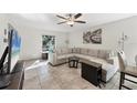 Spacious living room featuring neutral tones, tile flooring, and lots of natural light at 5060 Village Gardens Dr # 134, Sarasota, FL 34234