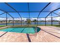 Screened-in pool offering stunning water views, perfect for relaxation and entertaining at 5127 54Th W St, Bradenton, FL 34210