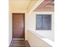 Cozy condo entrance with a secure door, striped mat, and a window with horizontal blinds at 5187 Lake Village Dr # 4, Sarasota, FL 34235